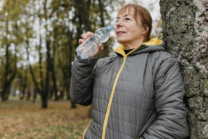 Hip pain in cold- woman drinking water